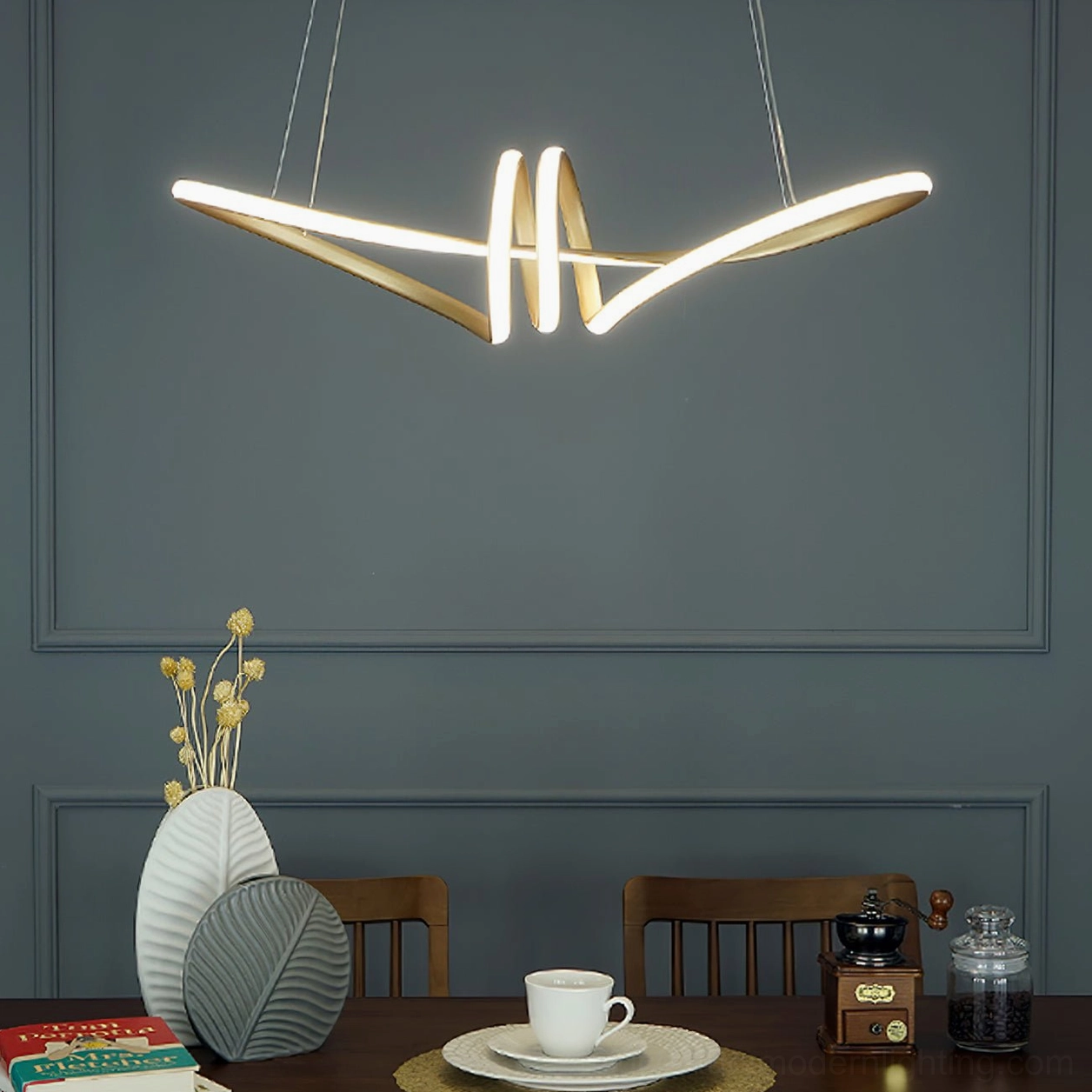 Minimalist blue wall dining room with simplified linear twisted LED chandelier, soft warm gold metal finish and contemporary design