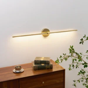 Modern gold linear wall lamp illuminating mid-century interior with wooden table and books