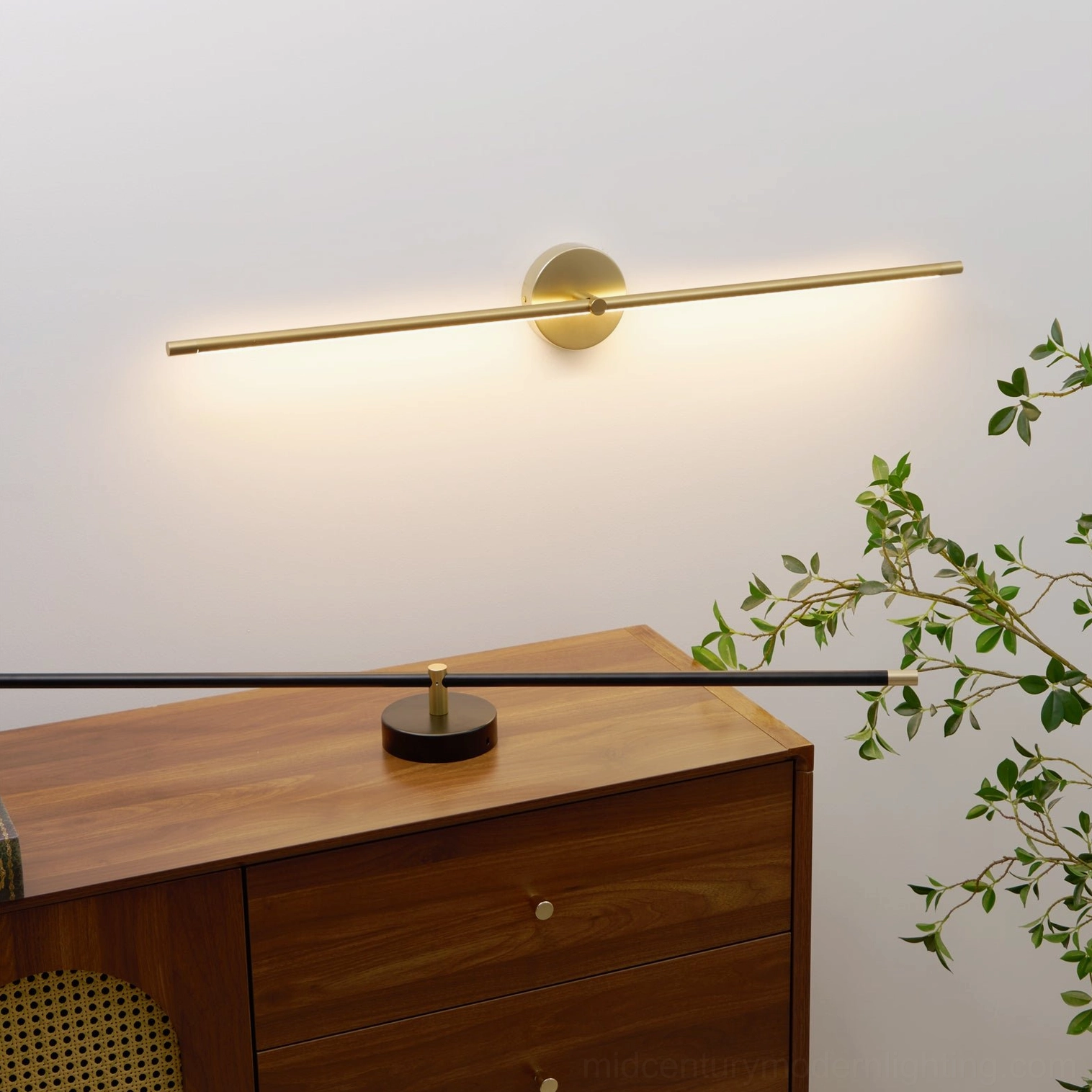 Modern minimalist linear wall lamp in gold finish at low angle perspective