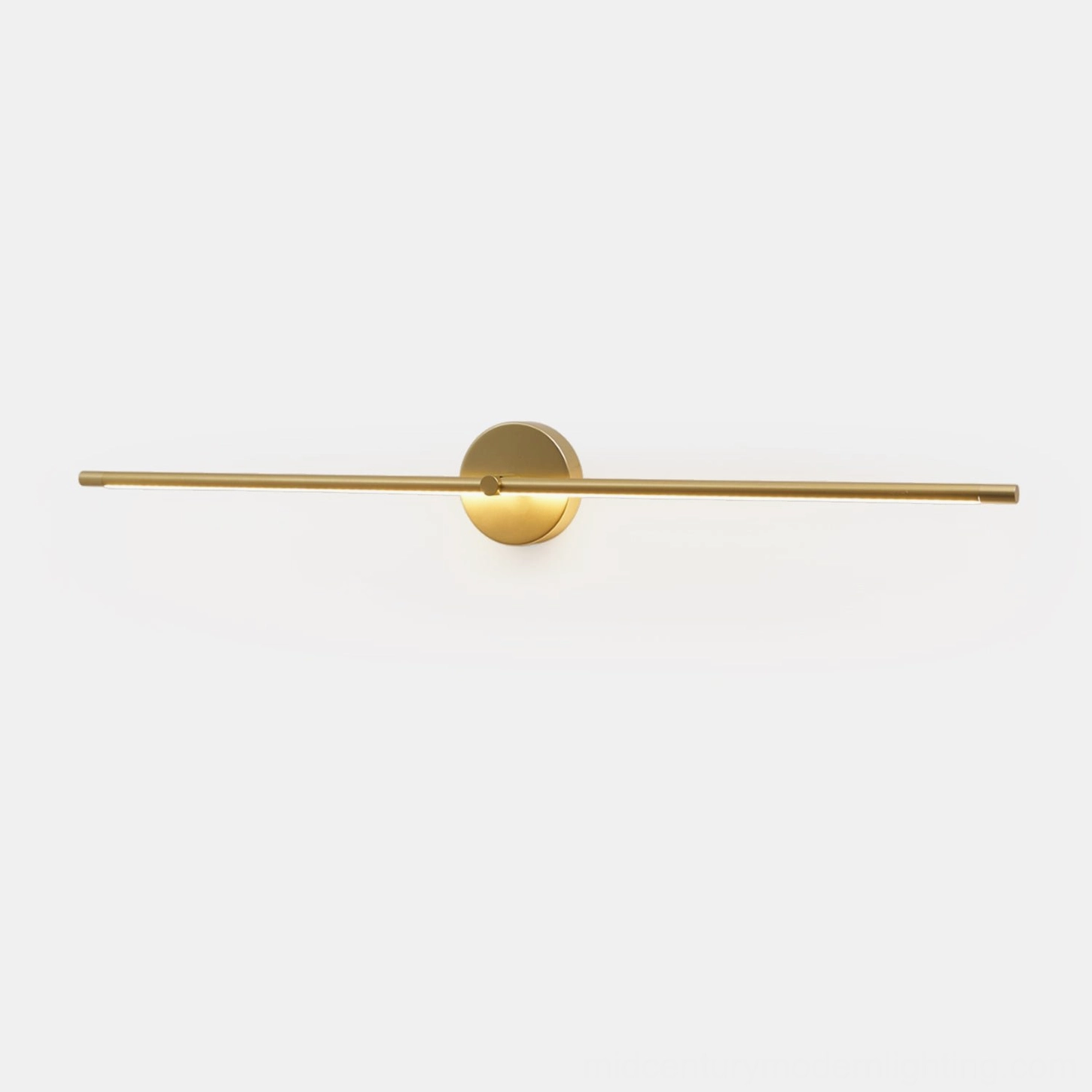 Long slim gold linear wall lamp creating continuous line of light in home interior