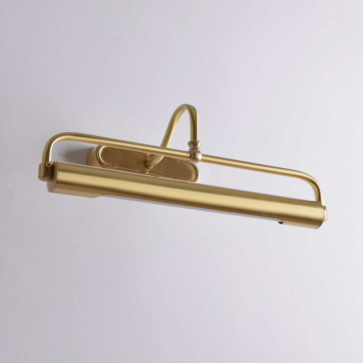 Gooseneck wall sconce styled above framed artwork in gallery setting, functional accent lighting