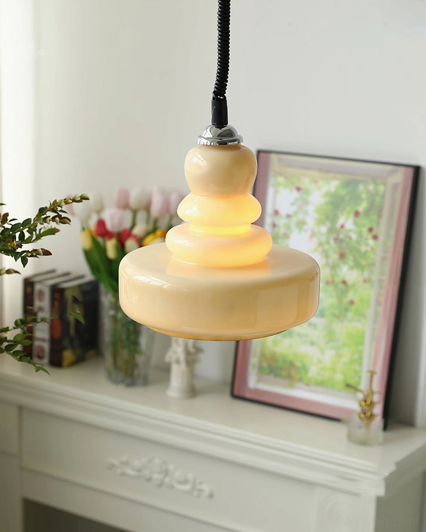 Illuminated beige gourd pendant light showing layered stacked glass design and soft light diffusion in cozy interior setting