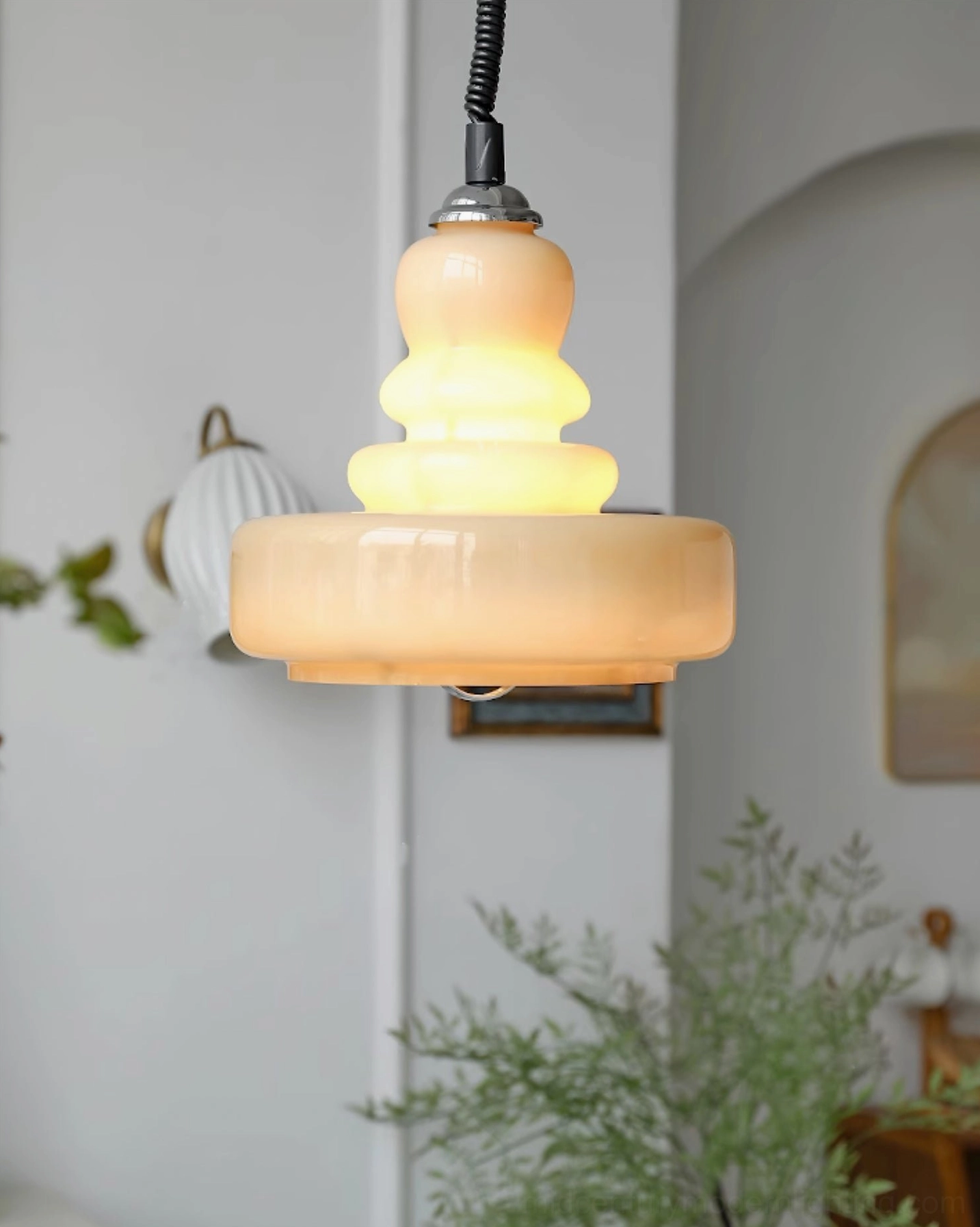 Layered gourd glass pendant light showing multi-plane light diffusion and shadow play in minimalist home setting