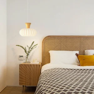 Gourd pendant light installed in modern Nordic bedroom with rattan headboard warm ambient lighting
