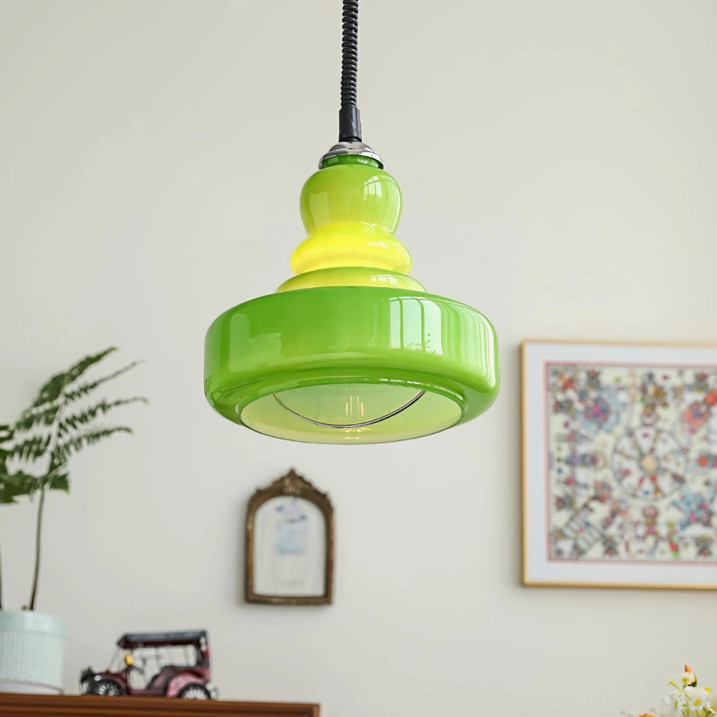 Gourd shaped glass pendant with tiered construction and warm ambient lighting in contemporary interior space