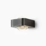 Grace modern wall sconce in matte black with integrated LED, front studio view
