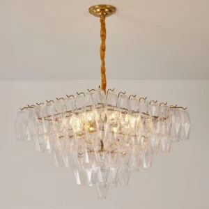 Clear glass Gramercy Diamond Chandelier with faceted prisms and twisted brass rod, warm ambient lighting indoors