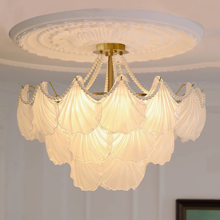 Grand three-layer scallop shell glass chandelier with brass hardware in luxury dining room setting