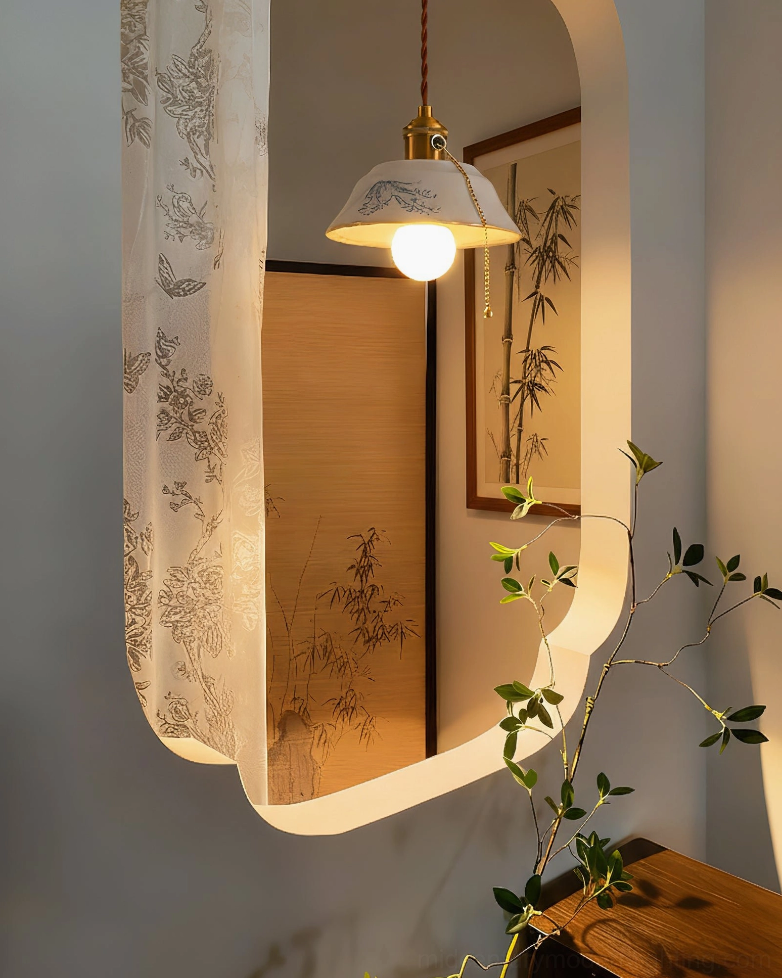 Handcrafted ceramic pendant light reflected in mirror of contemporary home with bamboo wall art