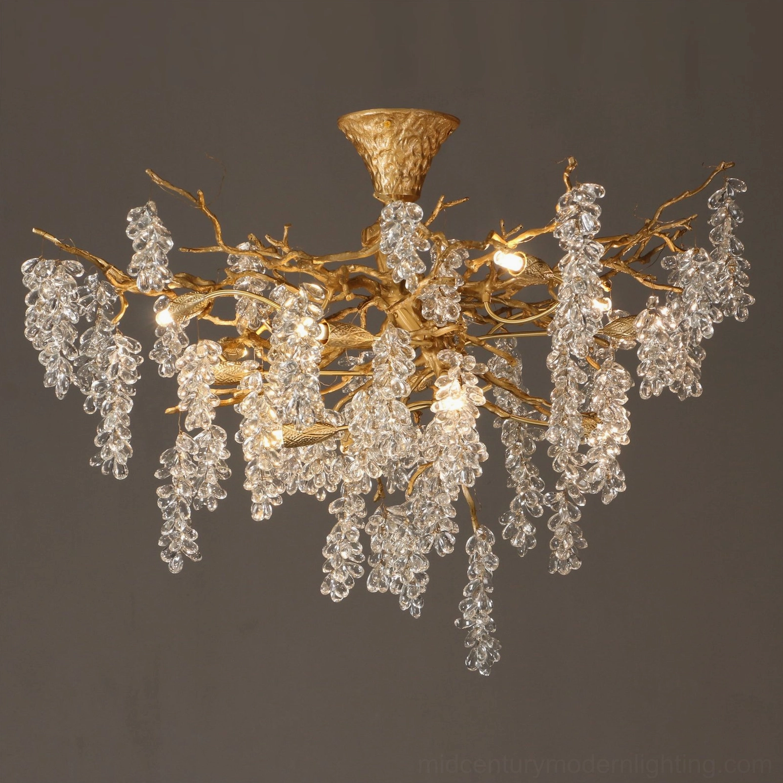 Semi-flush mount grape bunch chandelier displaying brushed gold branches with dangling crystal grape clusters on dark gray background