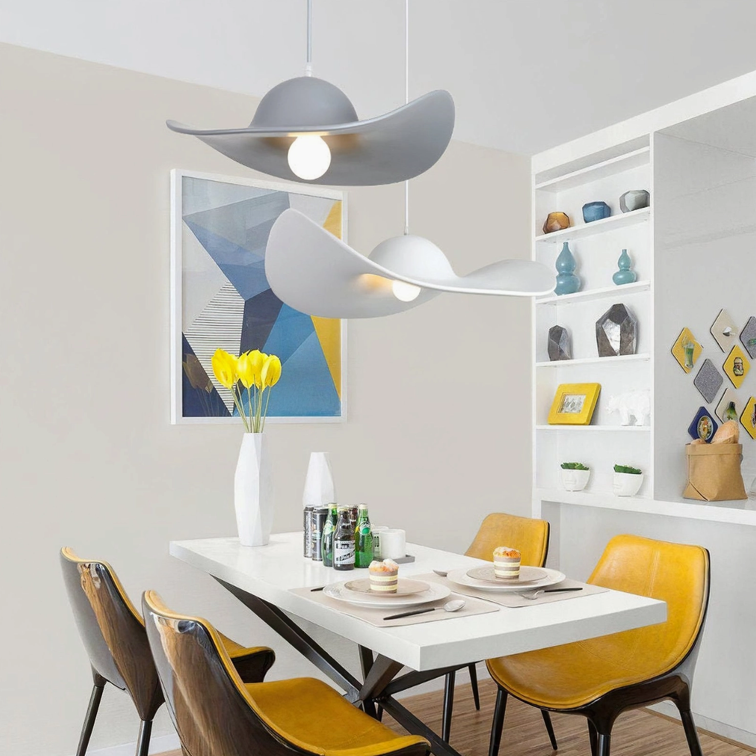 Gray and white hat pendant lights glowing above stylish dining area with yellow chairs