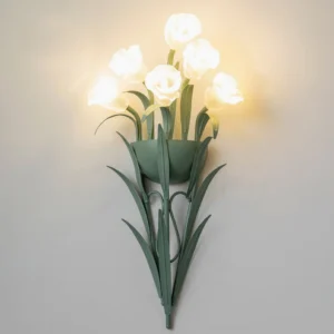 Lit calla lily wall lamp glowing with warm LED light, minimalist interior scene