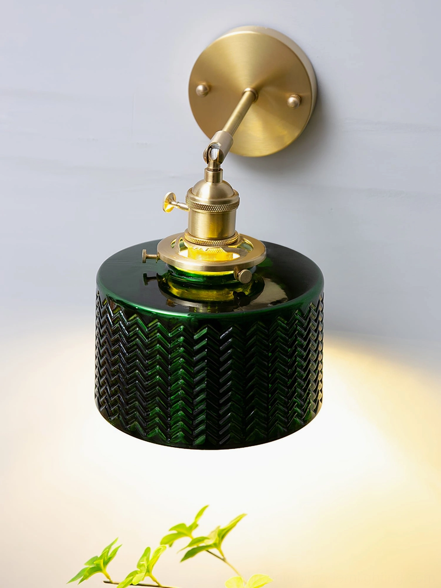 Close-up top-down view of green textured glass shade with integrated control switch detail
