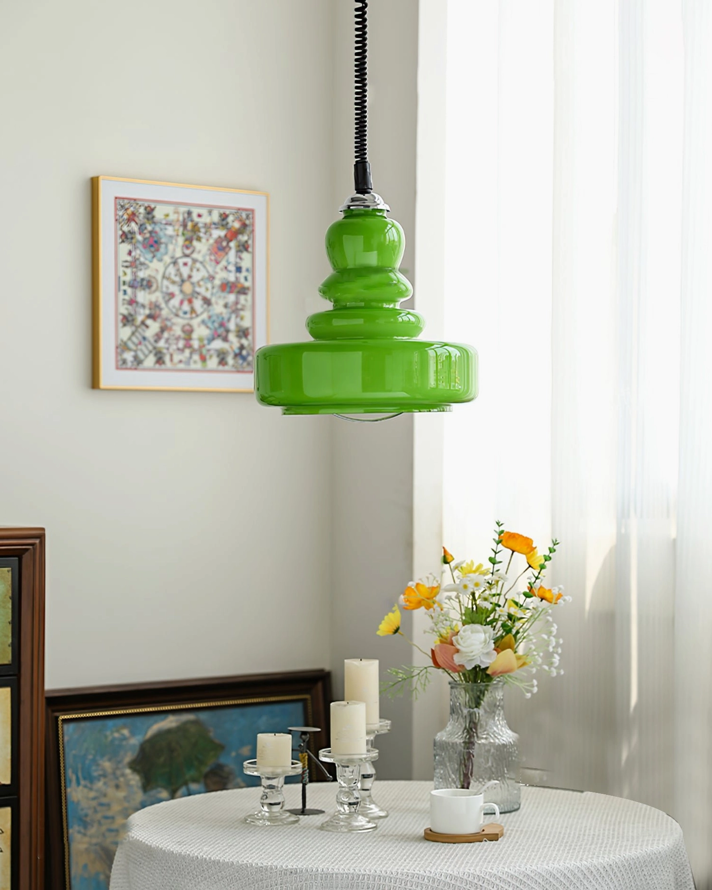 Bright green gourd stacked glass pendant light hanging in dining room with modern vintage style and floral table decoration