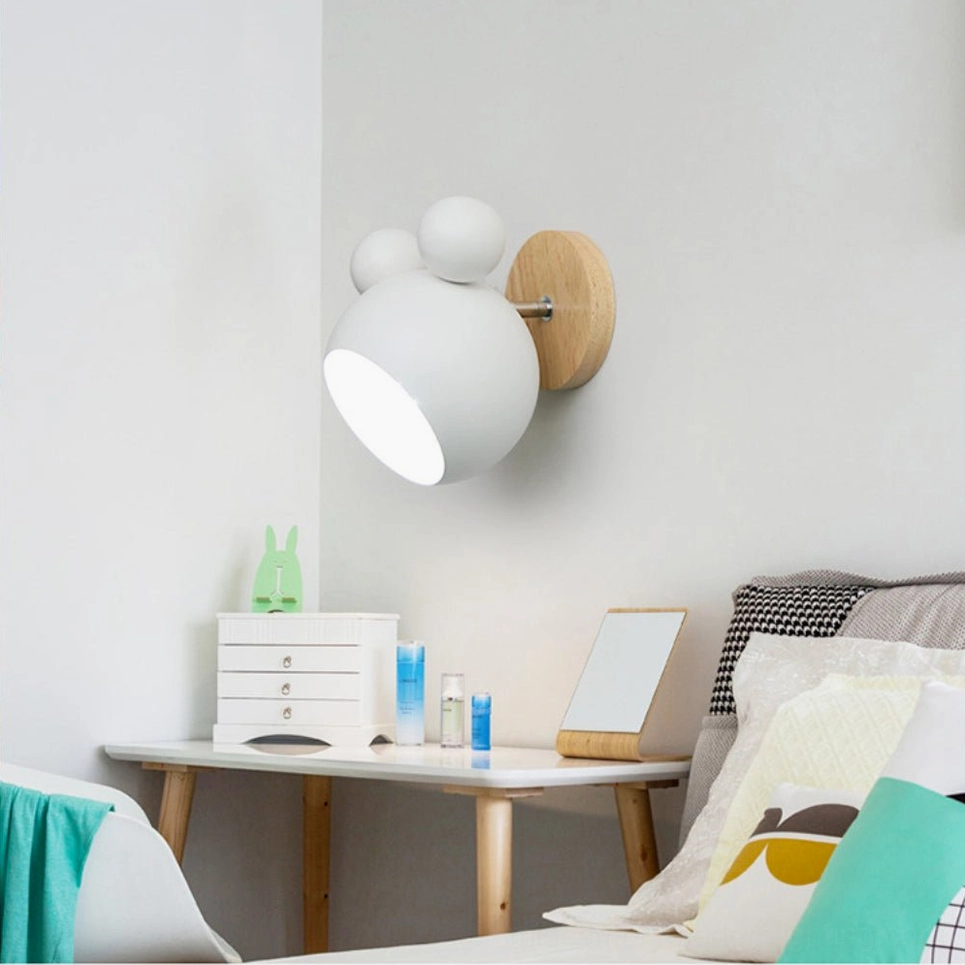 Green mouse wall lamp adding color accent to modern minimalist living room wall