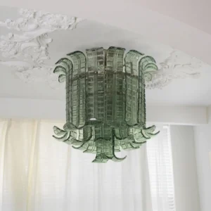 Green glass leaf ceiling lamp installed in bedroom, warm ambient lighting from textured panels, vintage luxury aesthetic