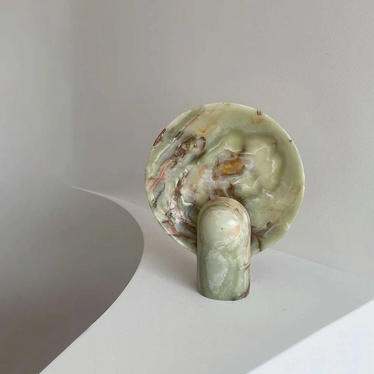 Green onyx marble table lamp three-quarter front perspective on white studio display showing unique soft veining and contemporary sculptural form