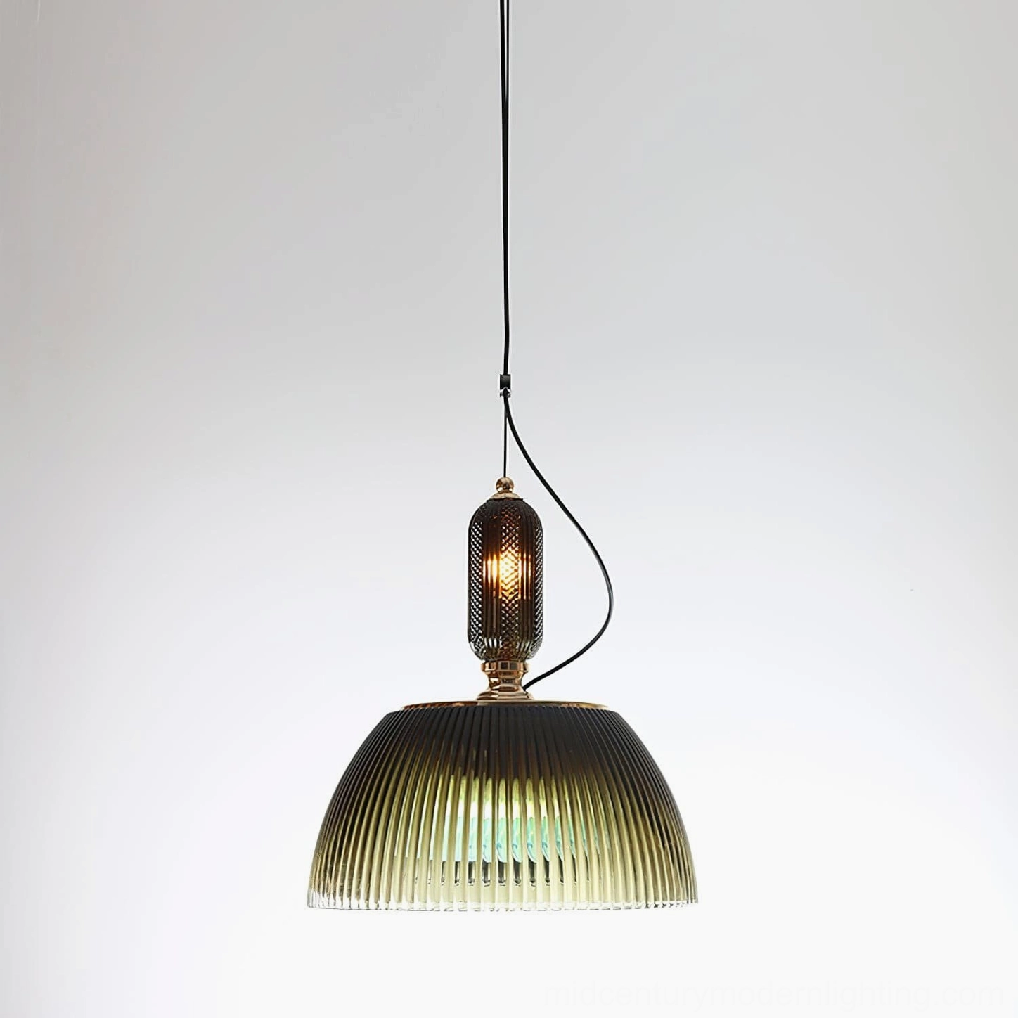 Front view of forest green ribbed glass pendant lamp with black suspension cord on white background