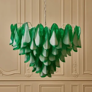Two-tone green-white glass chandelier displayed in vintage interior with carved panel wall, showing layered petal structure and metal hanging chain