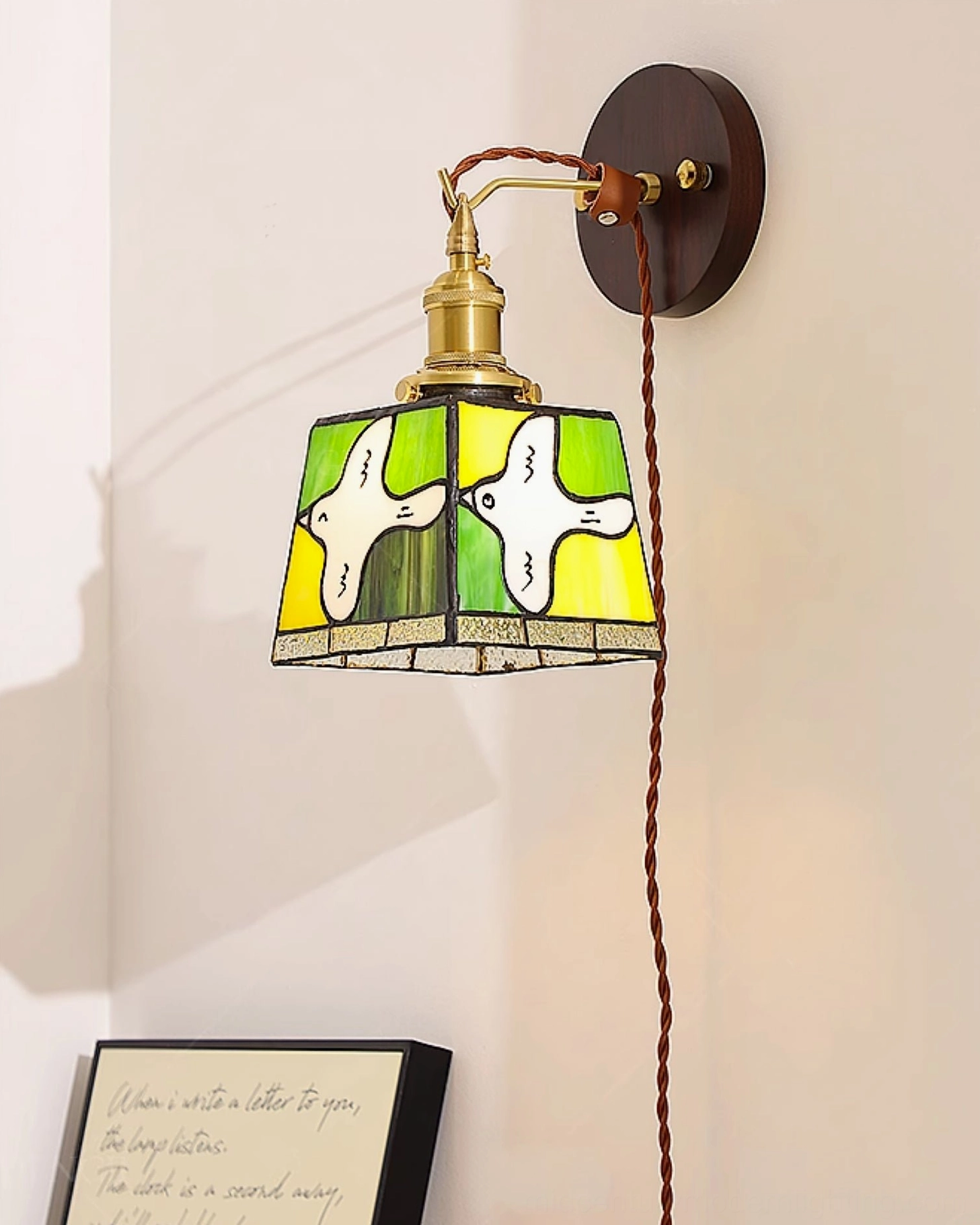 Green and yellow stained glass dove lamp with matching dark wood wall mount and brass fixtures