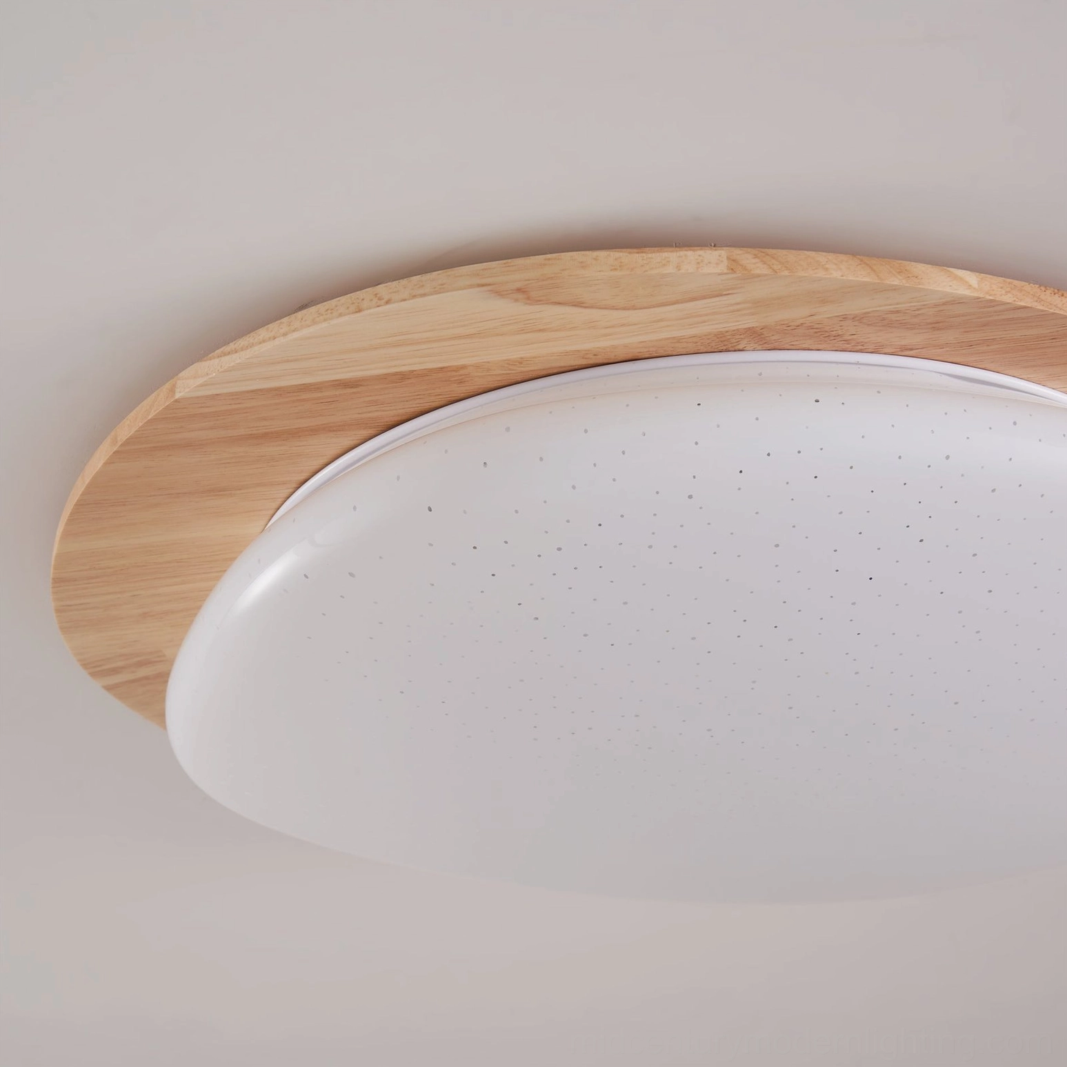 Gregg wood-trimmed flush mount ceiling lamp installed on residential ceiling, Scandinavian minimalist interior