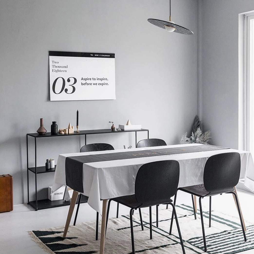 Single grey terrazzo pendant lamp in small modern dining space with minimalist contemporary decor