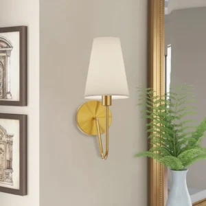 Brushed brass Griffin wall sconce mounted above bathroom vanity mirror, elegant vanity lighting in traditional bathroom setting