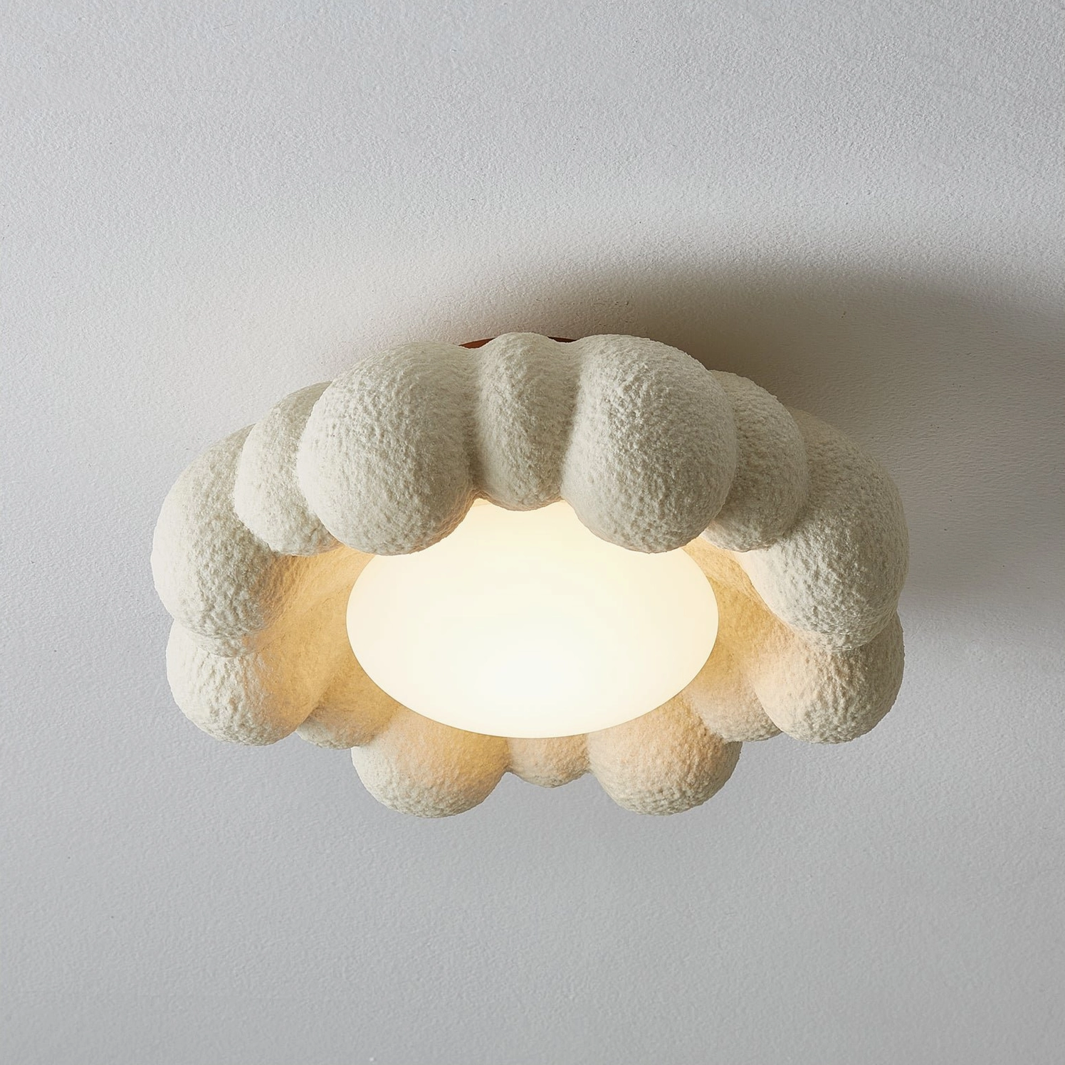 Extra-large Gross cloud ceiling fixture with unlit frosted resin diffuser, terracotta base, close-up architectural view