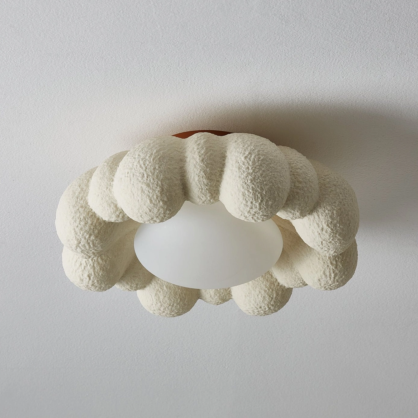Gross flush mount cloud ceiling lamp showing architectural design, warm light diffusion through textured resin material
