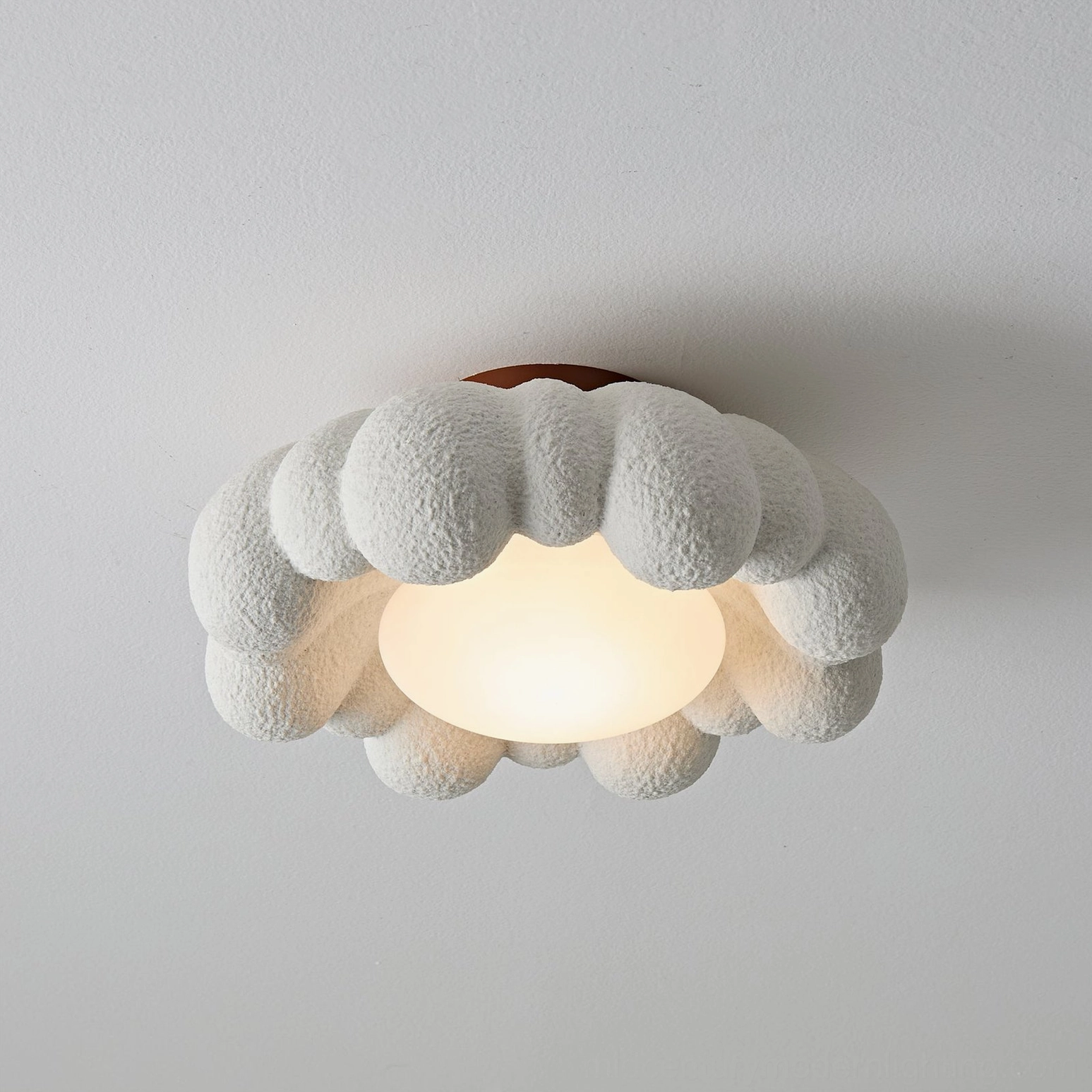 Medium-sized Gross cloud flush mount ceiling light with terracotta base, warm light emission, overhead flat perspective