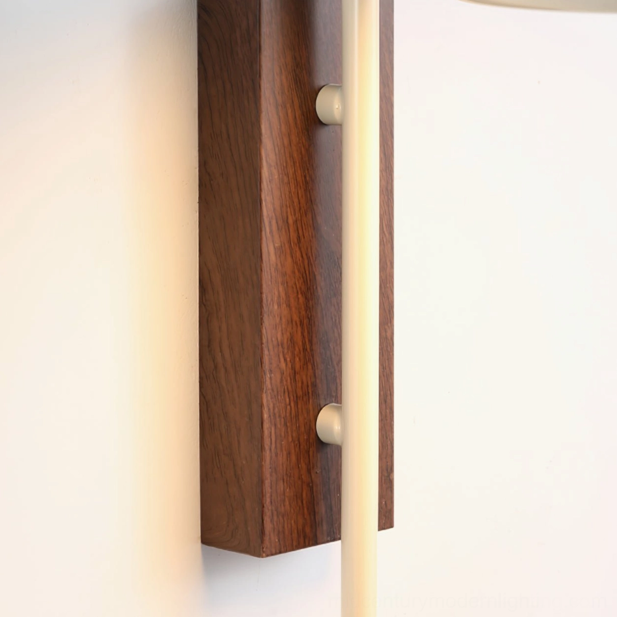 Grote wall sconce mounted in bedroom reading nook, warm ambient lighting for relaxation