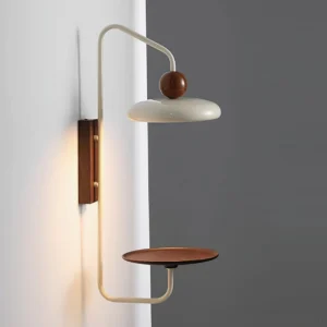 Side profile of Grote wall-mounted sconce showing integrated tray shelf with warm LED lighting
