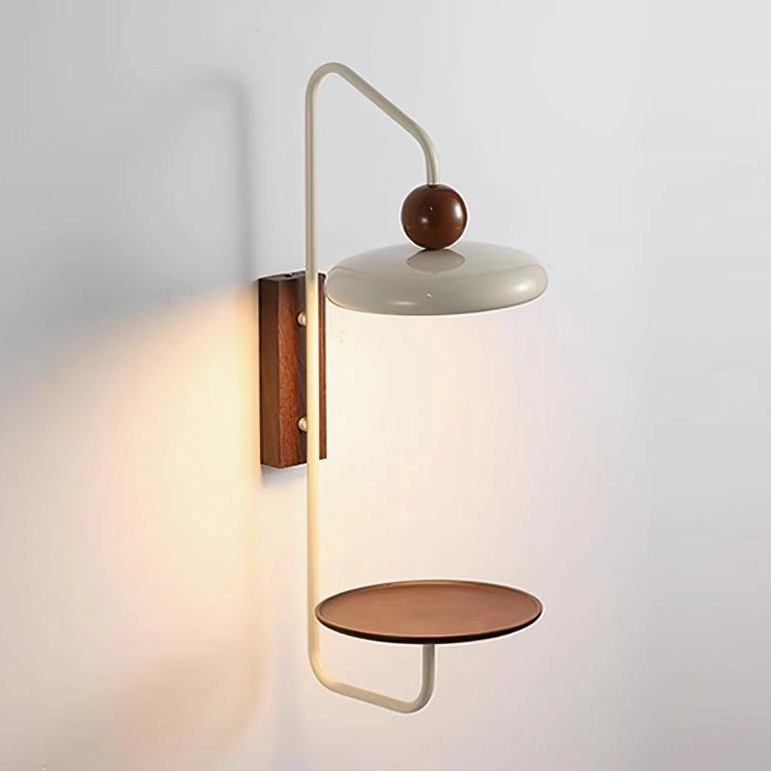 Grote wall-mounted sconce with warm LED lighting and integrated storage shelf, three-quarter view
