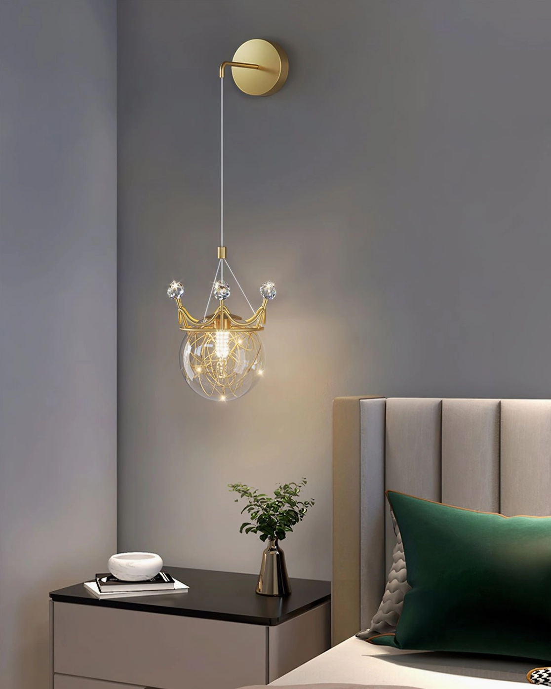 Crown wall sconce in modern bedroom interior with green accent pillow and botanical decorations