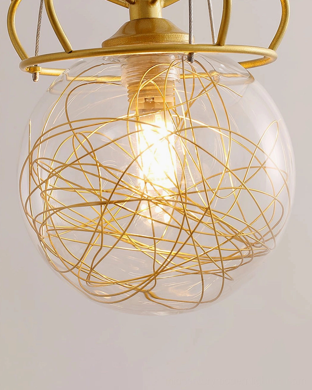 Close-up overhead view of hand-blown glass bulbs with gold twisted wire interior and exposed bulb design