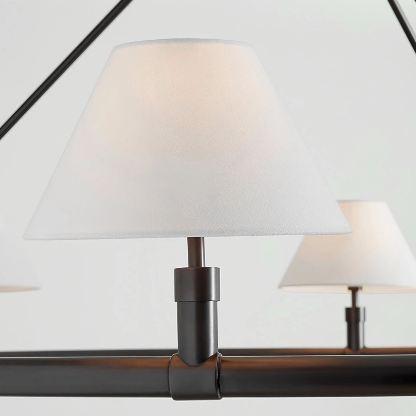 Black six-arm chandelier with white tapered fabric shades, macro front view