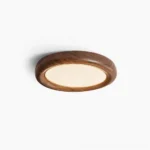 Haines mid-century modern round flush mount ceiling lamp in walnut finish, front overhead studio view with minimalist white background
