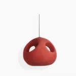 Halia red pendant lamp studio shot - spherical terracotta foam pendant with oval cutouts on white background