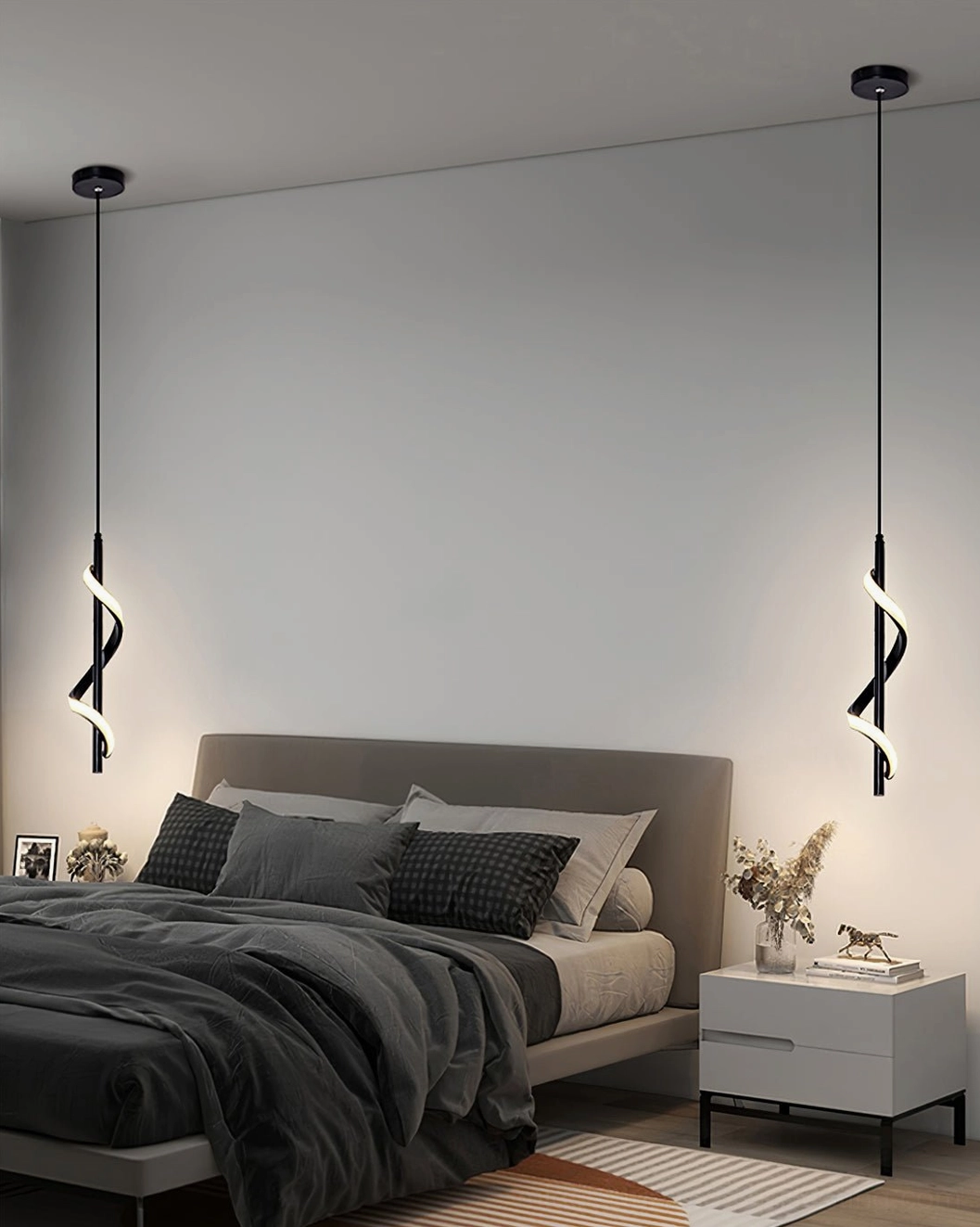Pair of black Hamburg spiral pendant lamps symmetrically installed above double bed in modern master bedroom