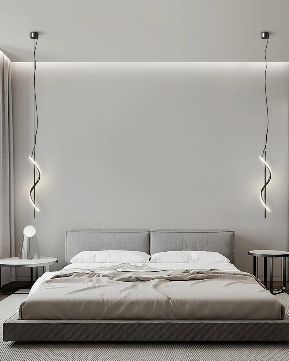 Dual Hamburg spiral LED pendants in neutral finish hanging symmetrically in minimalist master bedroom with soft lighting