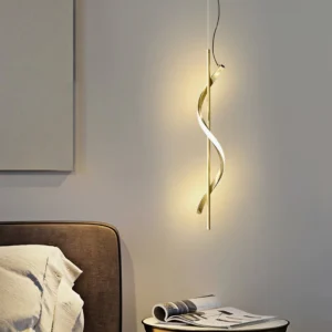 Polished gold Hamburg pendant lamp installed in bedroom bedside area with warm ambient lighting and twisted spiral structure