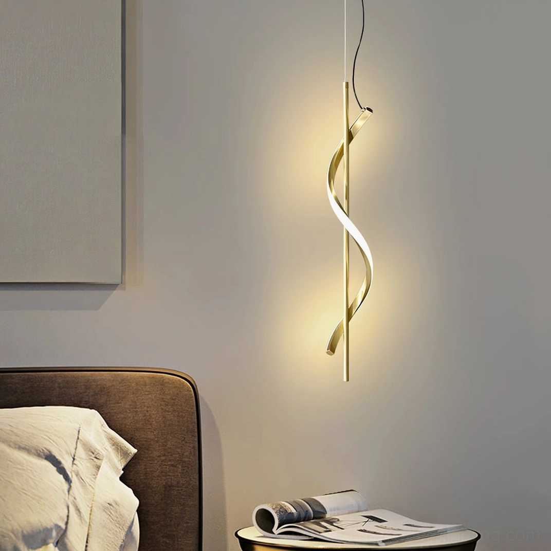 Polished gold Hamburg pendant lamp installed in bedroom bedside area with warm ambient lighting and twisted spiral structure