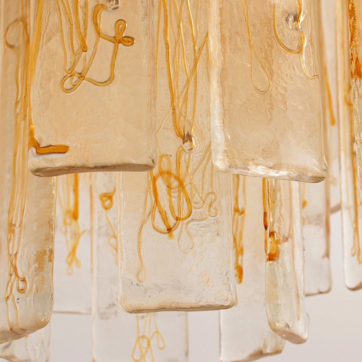 Macro view of swirled amber glass veins showing the artisanal hand-blown glass craftsmanship and depth