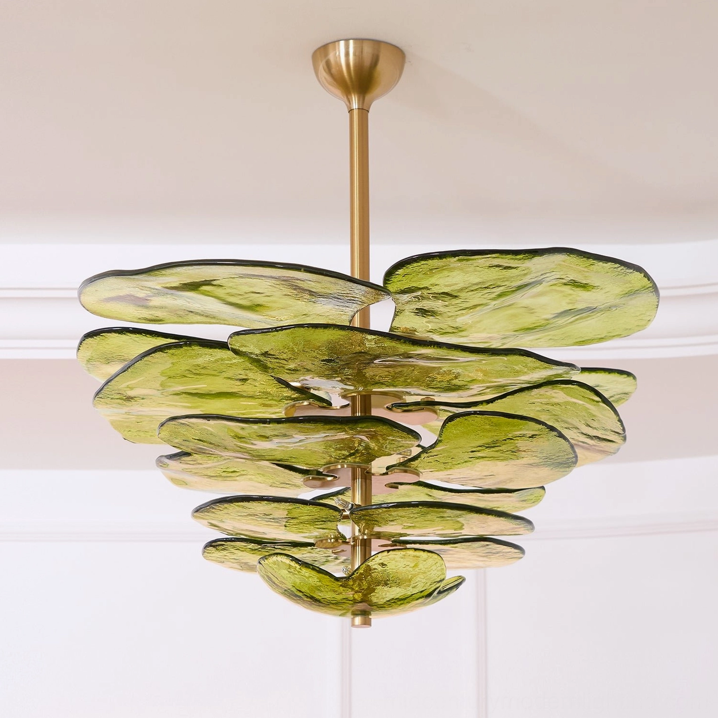 Hand-blown lotus flower chandelier with glass petal arrangement and warm ambient lighting