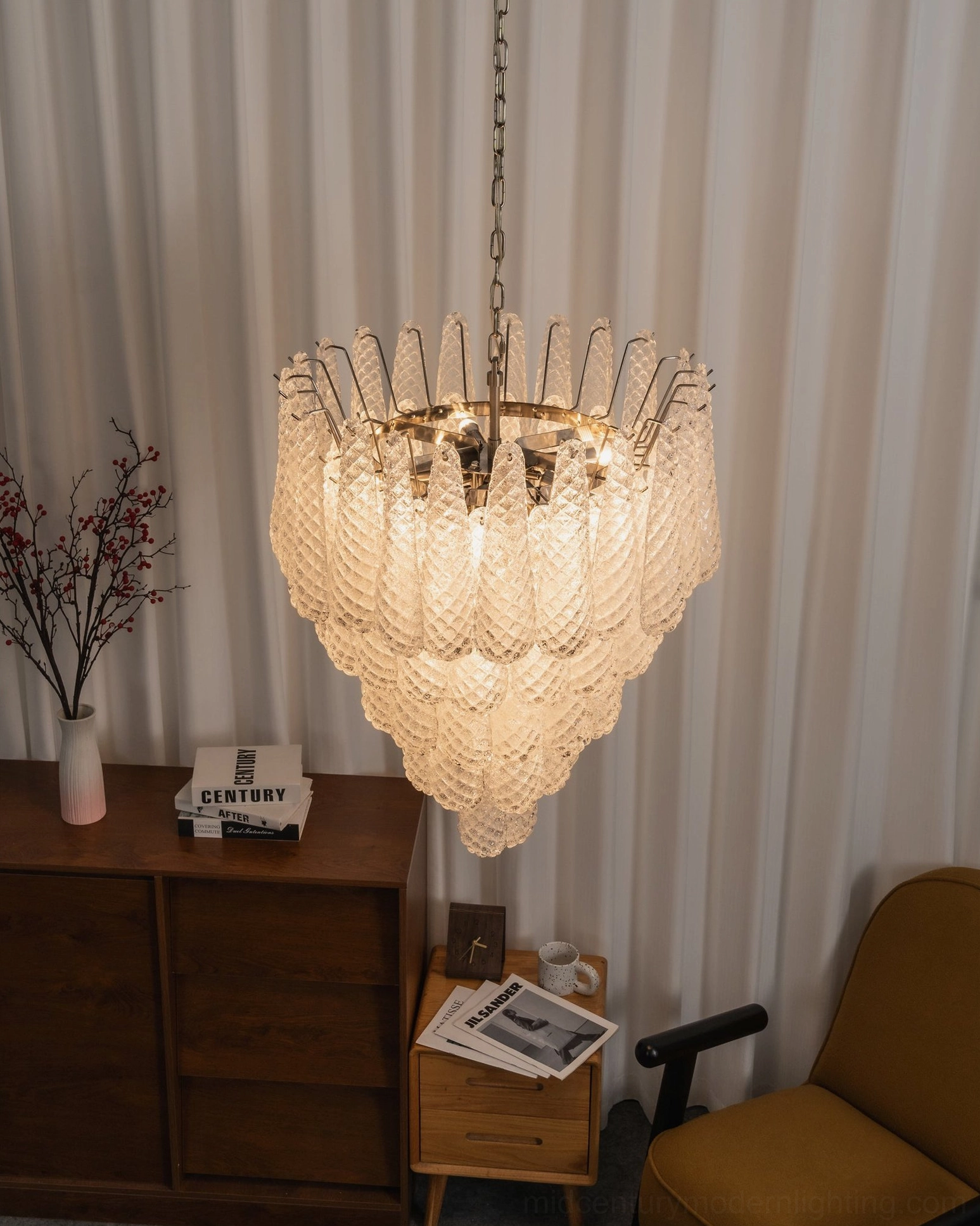 Tiered white glass chandelier with quilted texture pendant detail installed in classic living room with wooden furniture and vintage decor
