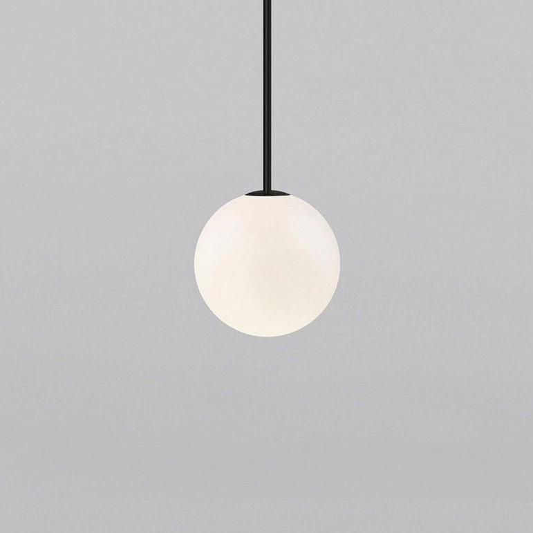 Hand-blown opal glass globe pendant showing artisanal texture and light diffusion quality