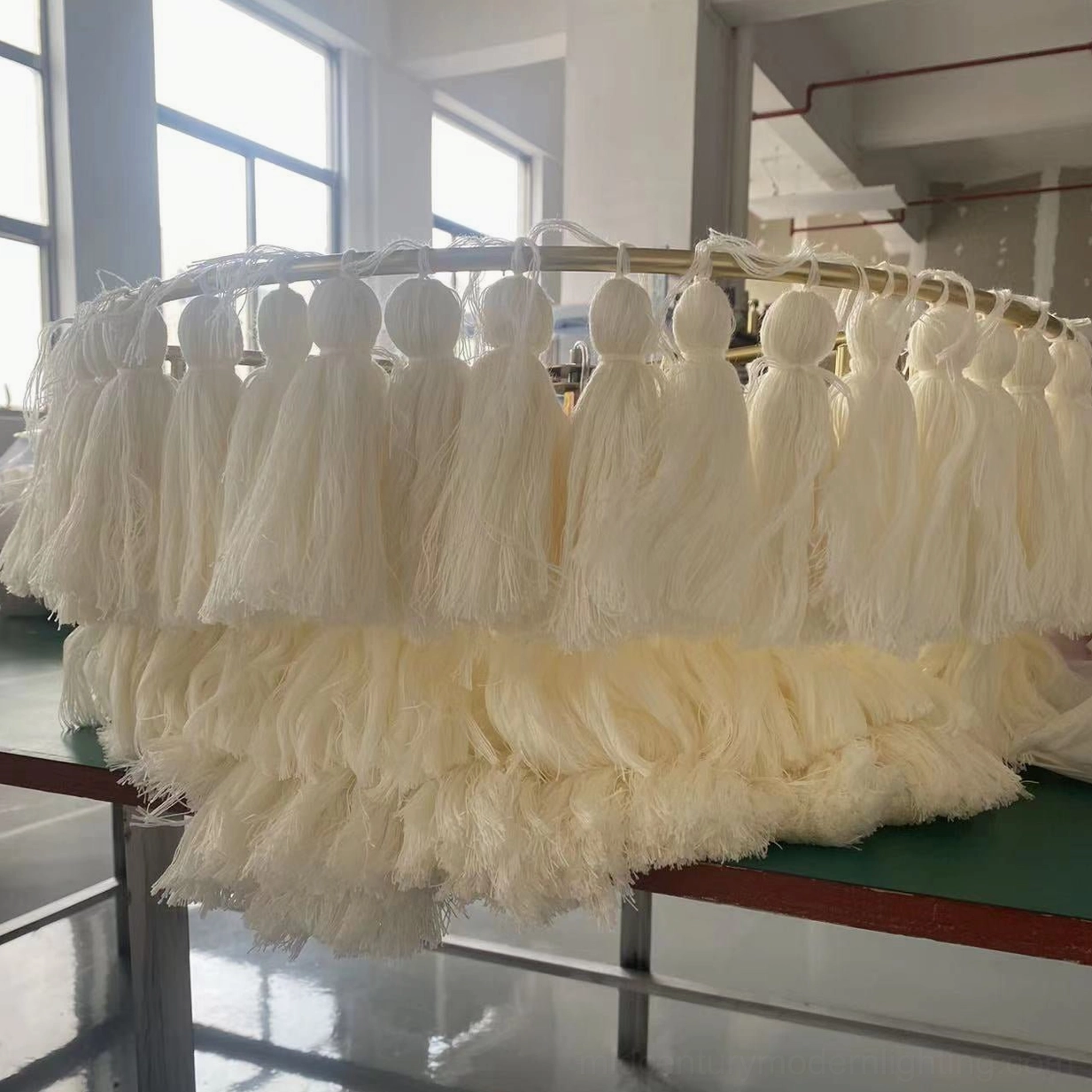 Close-up detail of fluffy bohemian tassel chandelier showing layered fabric construction and texture