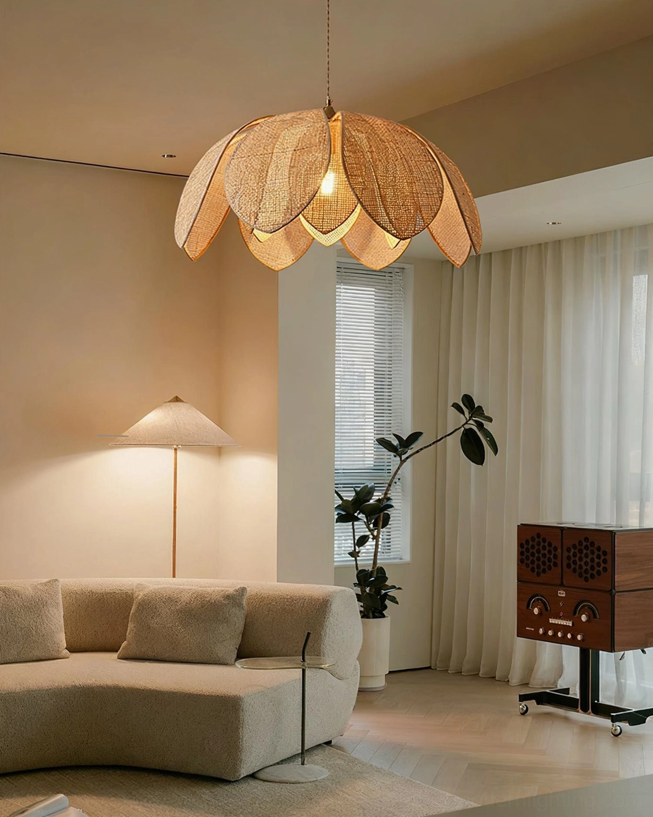 Hanove woven rattan pendant lamp in cozy living room setting with sofa and floor lamp, warm neutral tones