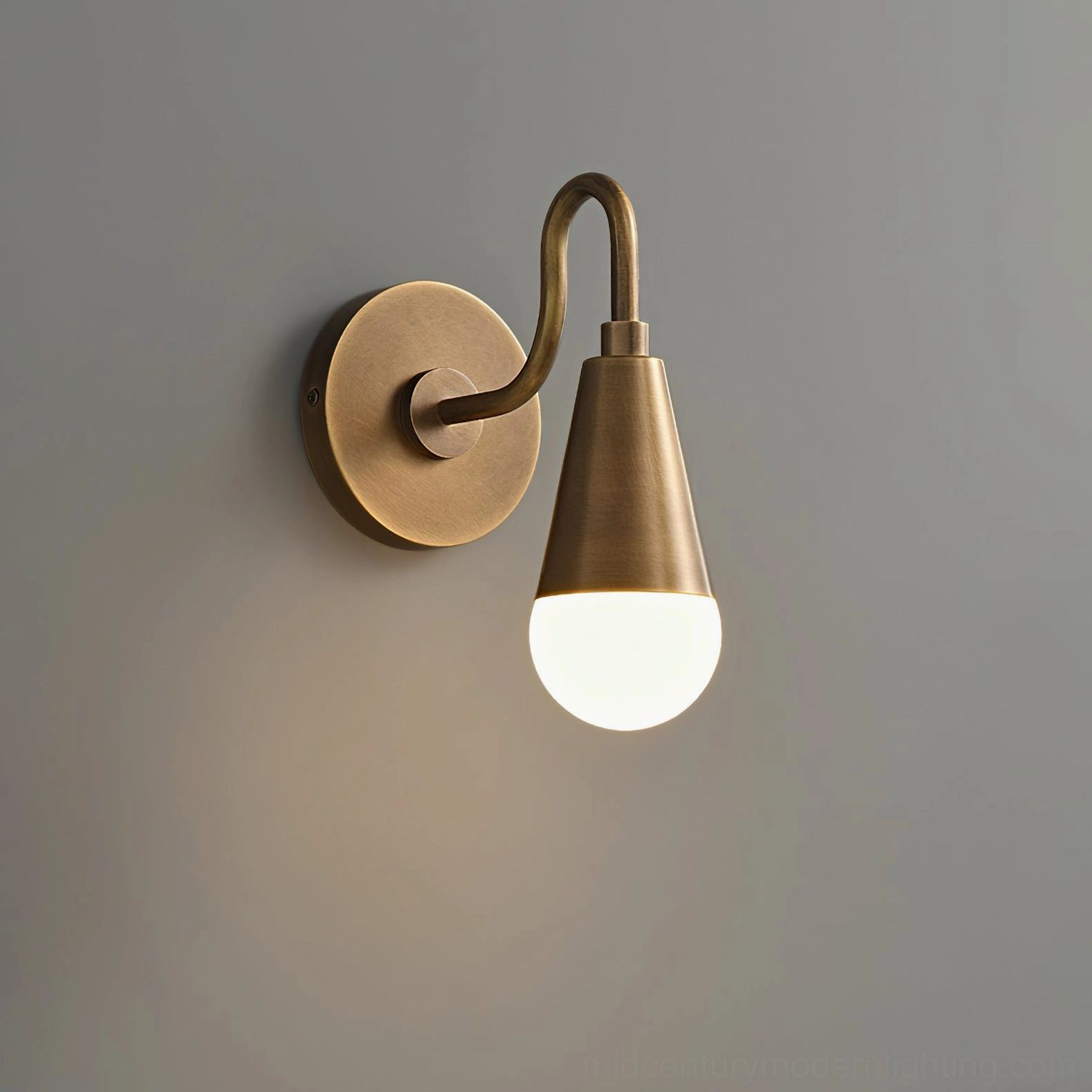 Harlan Gooseneck Wall Sconce lit frosted glass bulb, frontal studio view, antique brass industrial design fixture