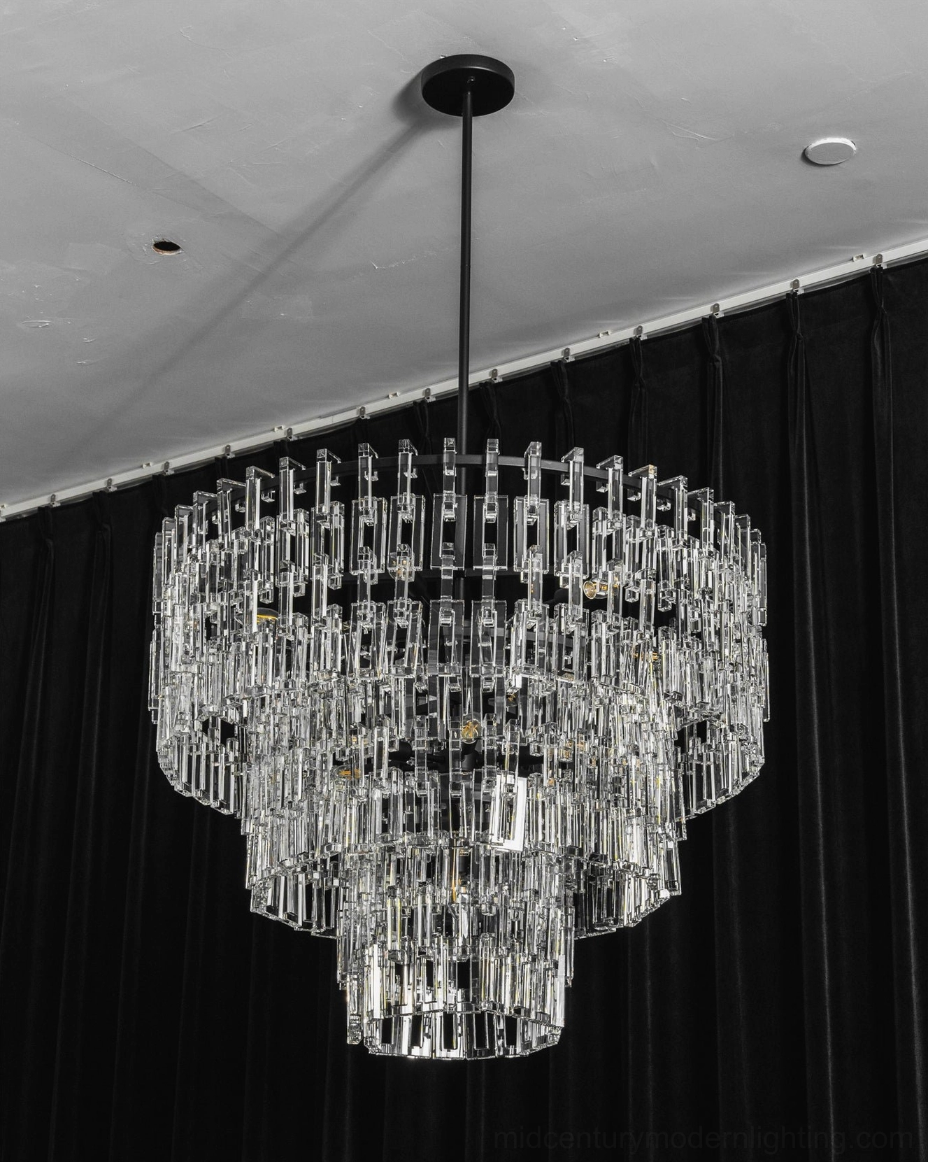 Close-up of Harlow tiered crystal chandelier cascading crystal matrix light refraction detail